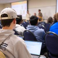 room full of college students listening to presentation